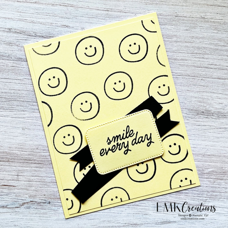 yellow card with black smiley faces and the saying smile every day